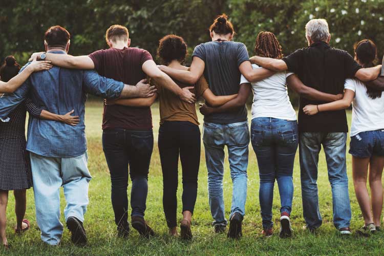 Group of people cross armed in a park